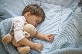 Cute little kid sleeping. Little boy sleeping in bed Cute little boy sleeping, tired child taking a nap in his small bed, clean, fresh and cozy bedding sheets, bedtime for kids