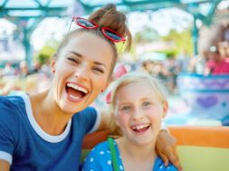 mother and child tourists in theme park enjoying attraction