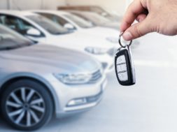Man’s hand holding car key.Automobile rent or leasing concept.